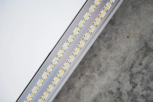 High-density flexible LED strip light displaying individual LED diodes and thermal backing layer.